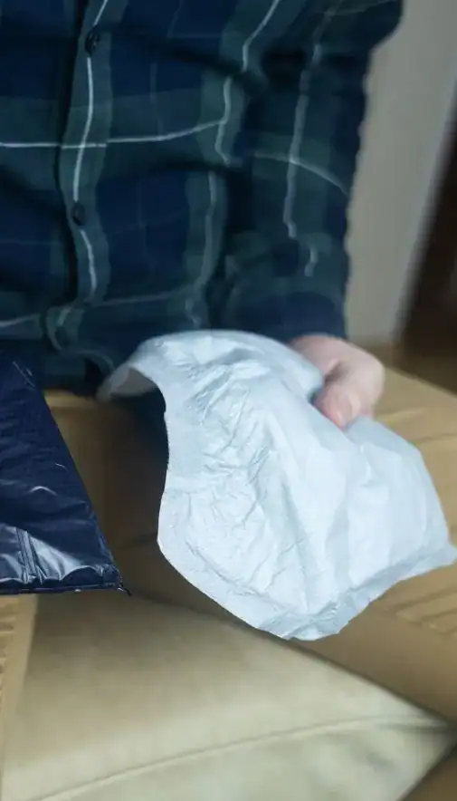 Image of man holding incontinence pads as part of overactive bladder treatment Stockport