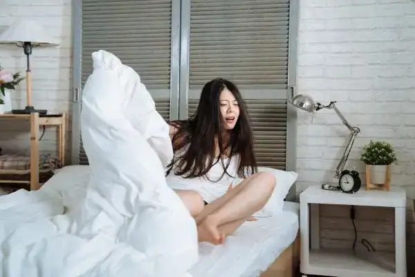 Image of woman getting up because of nighttime leaks Stockport